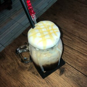 Iced coffee with straw and foam