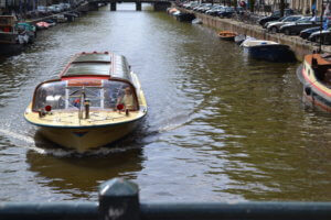 A boat cruising down Amsterdam canal