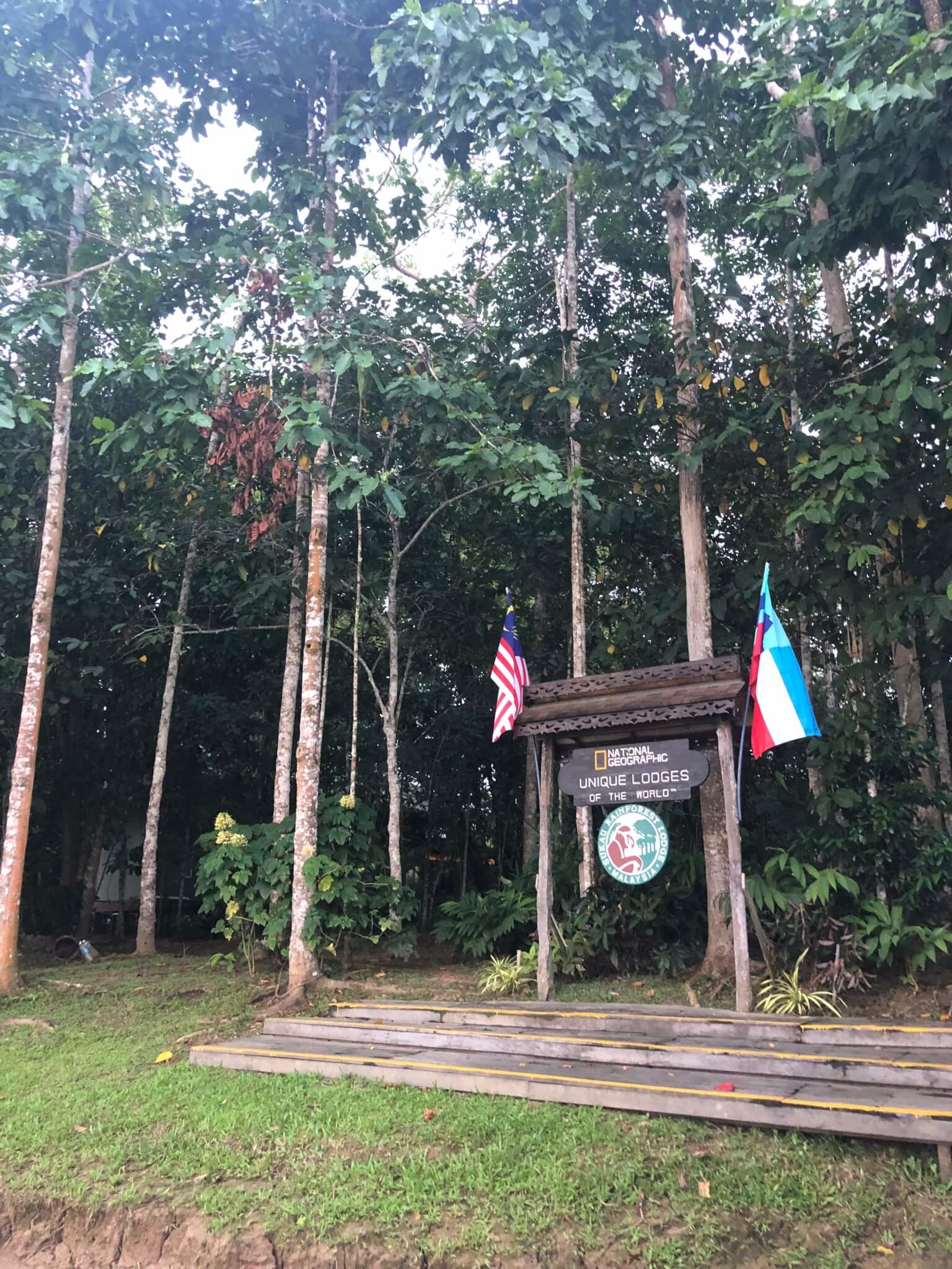 Sign of Nat Geo Unique Lodges of the World with Sabah and Malaysia flags.