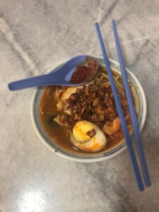 Bowl of Hokkien Mee with Blue Chopsticks and Spoon