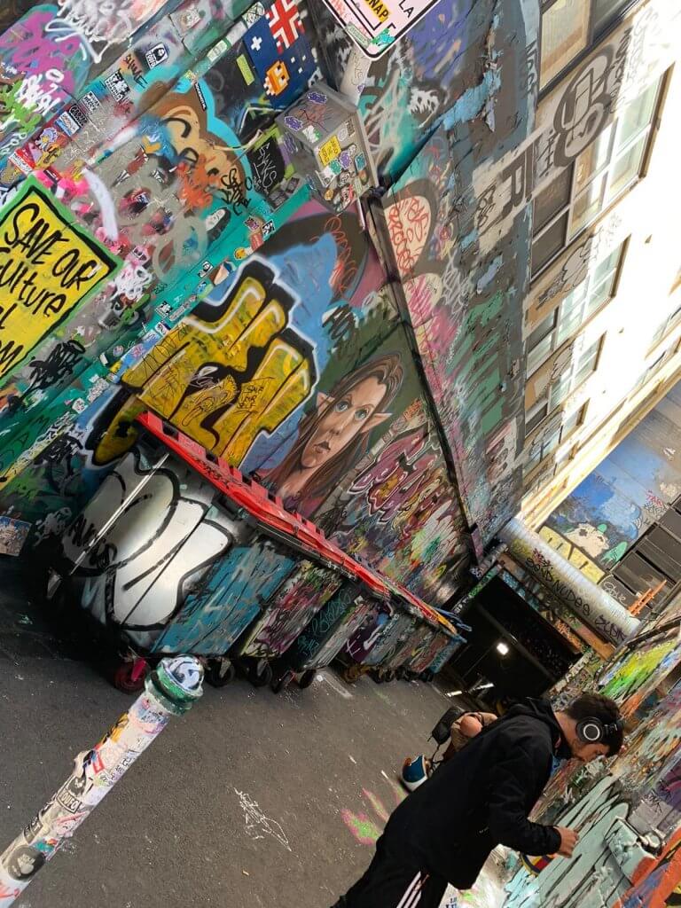 Artists working in Hosier Lane creating new street art