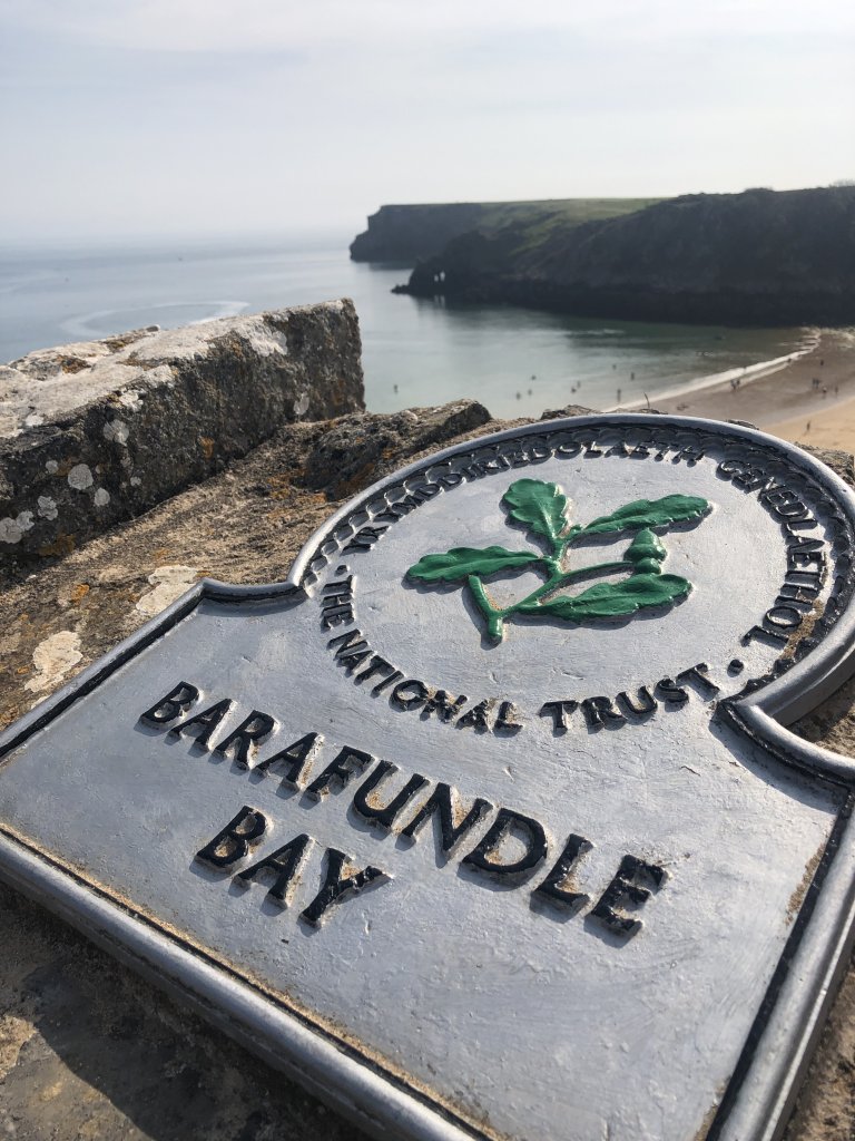Barafundle Bay in Pembrokeshire Wales National Trust Sign with Beach in Background 