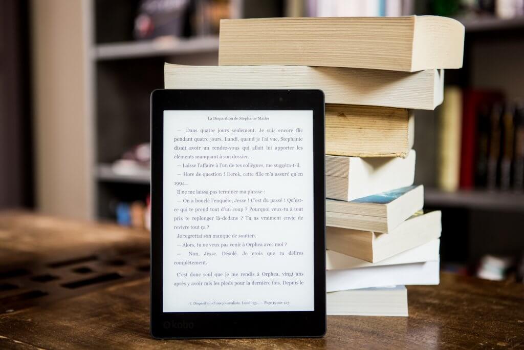 Kindle E-Reader with Stacked Books Pexels Image Stock
