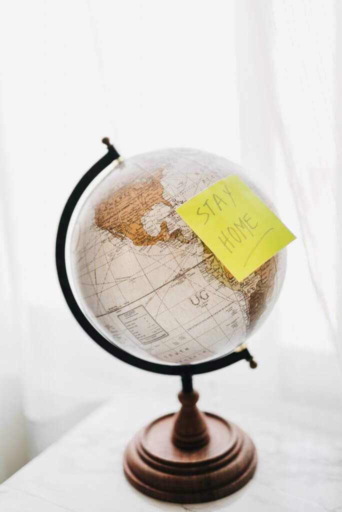 Stay Home Postit Note on a White Globe