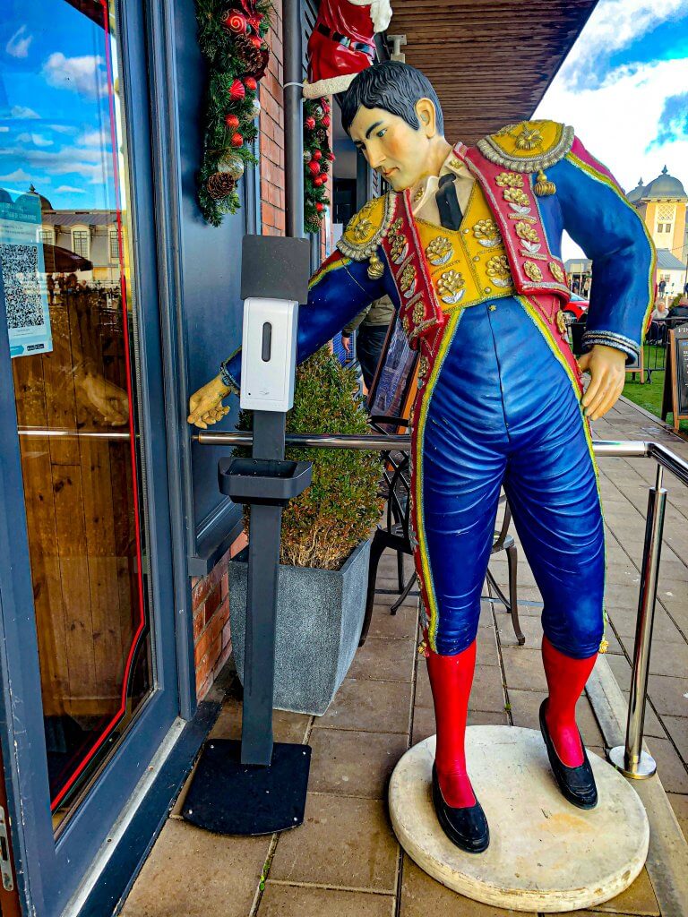 Picture of Matador in blue, red and yellow outfit outside Casa de margarita in Penarth Wales