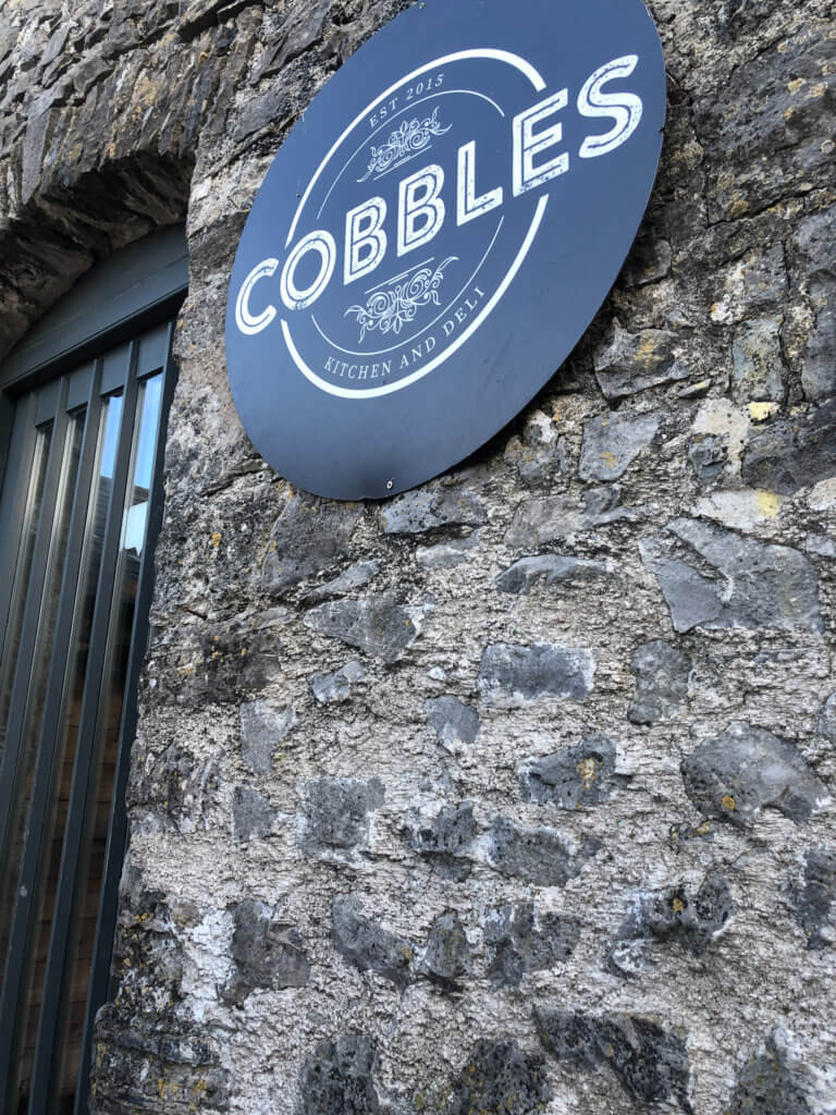 Cobbles Kitchen sign on bricked wall Southerndown