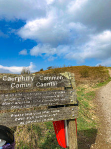 Caerphilly Common sign on left hand side of photo with path in background