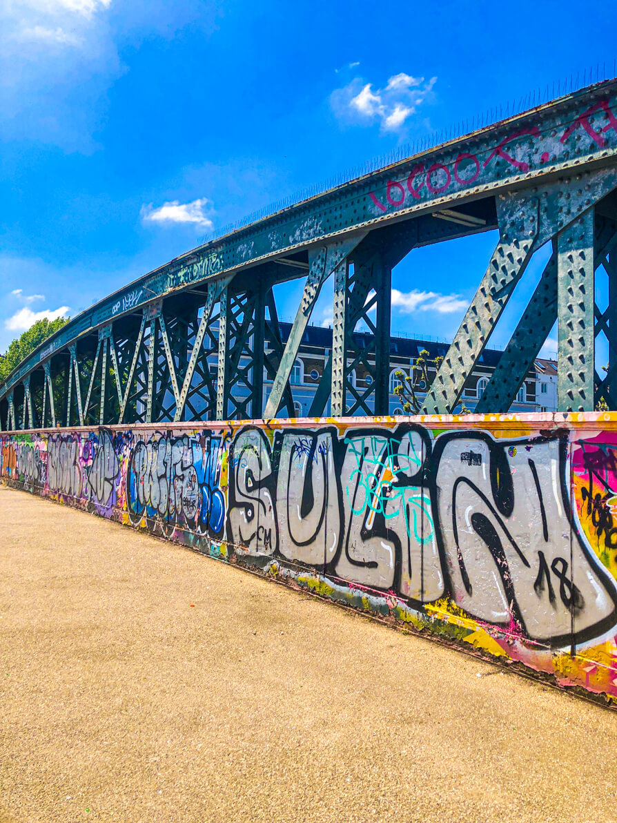Camden to primrose Hill bridge, view of the right hand side with graffiti on it. Blue sky in background.