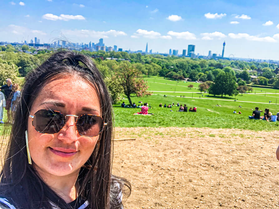 Shireen in front left of image with skyline of London in background at the top of Primrose Hill