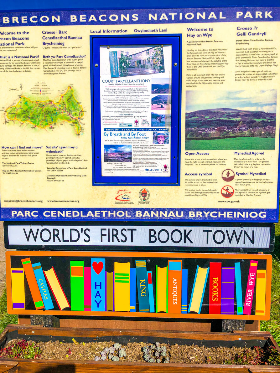 World's first book town sign in Hay on Wye with tourist information board in Hay on Wye car park