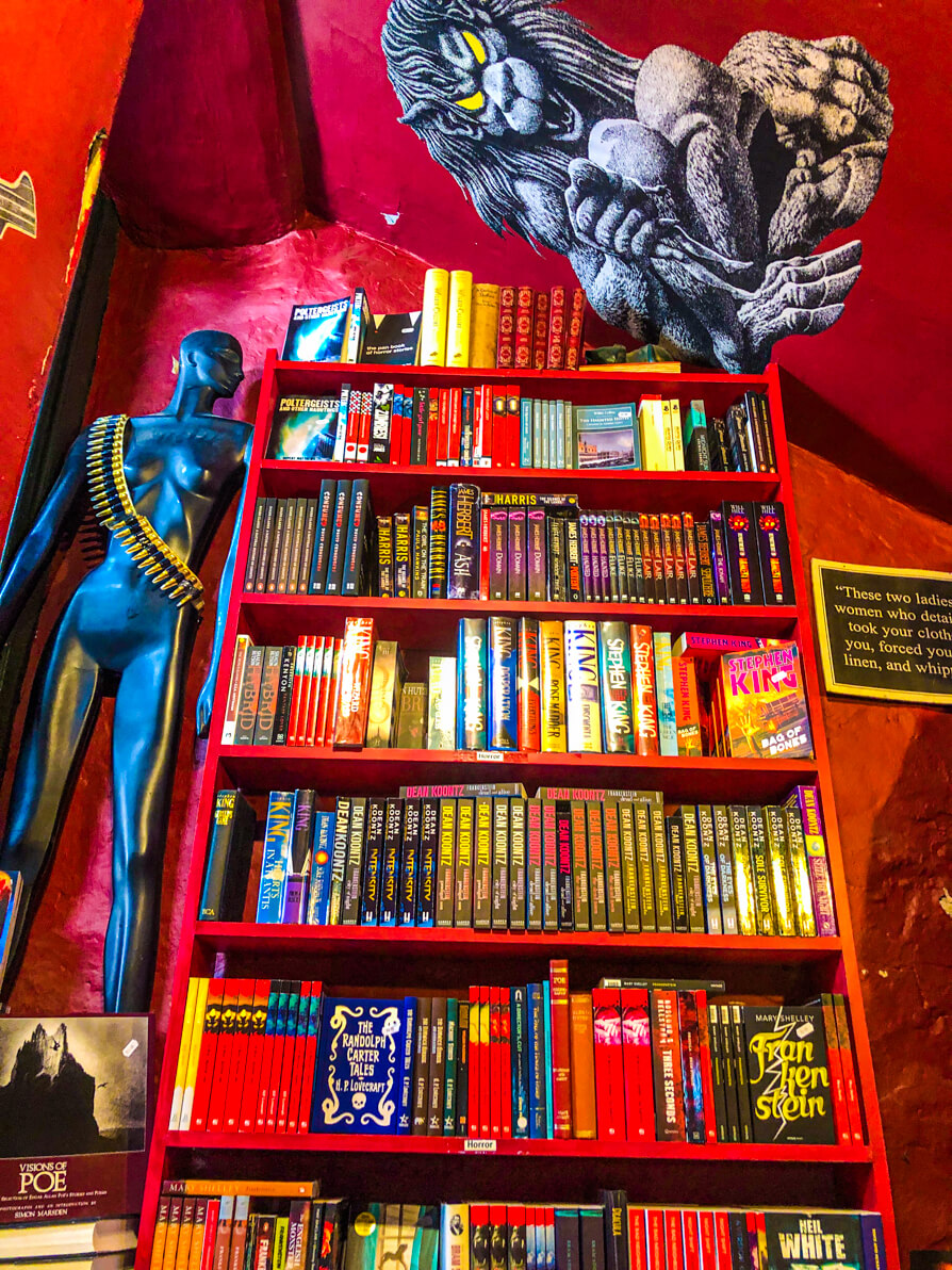 Murder and Mayhem red shelf at top of staircase horror section - Hay on Wye bookshops tour