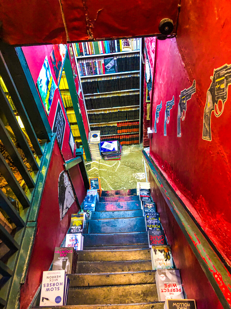 Murder and Mayhem red staircase with books on side of every step - Hay on Wye bookshops tour
