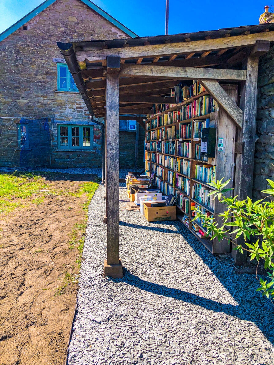 Side view of left hand bookshelf of honesty bookshop in Hay on Wye Castle