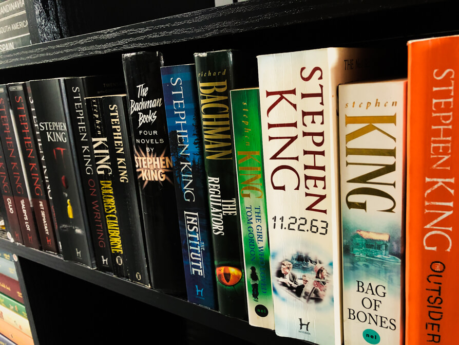 Image of Stephen King Novels collection in a black bookcase in colour coordination