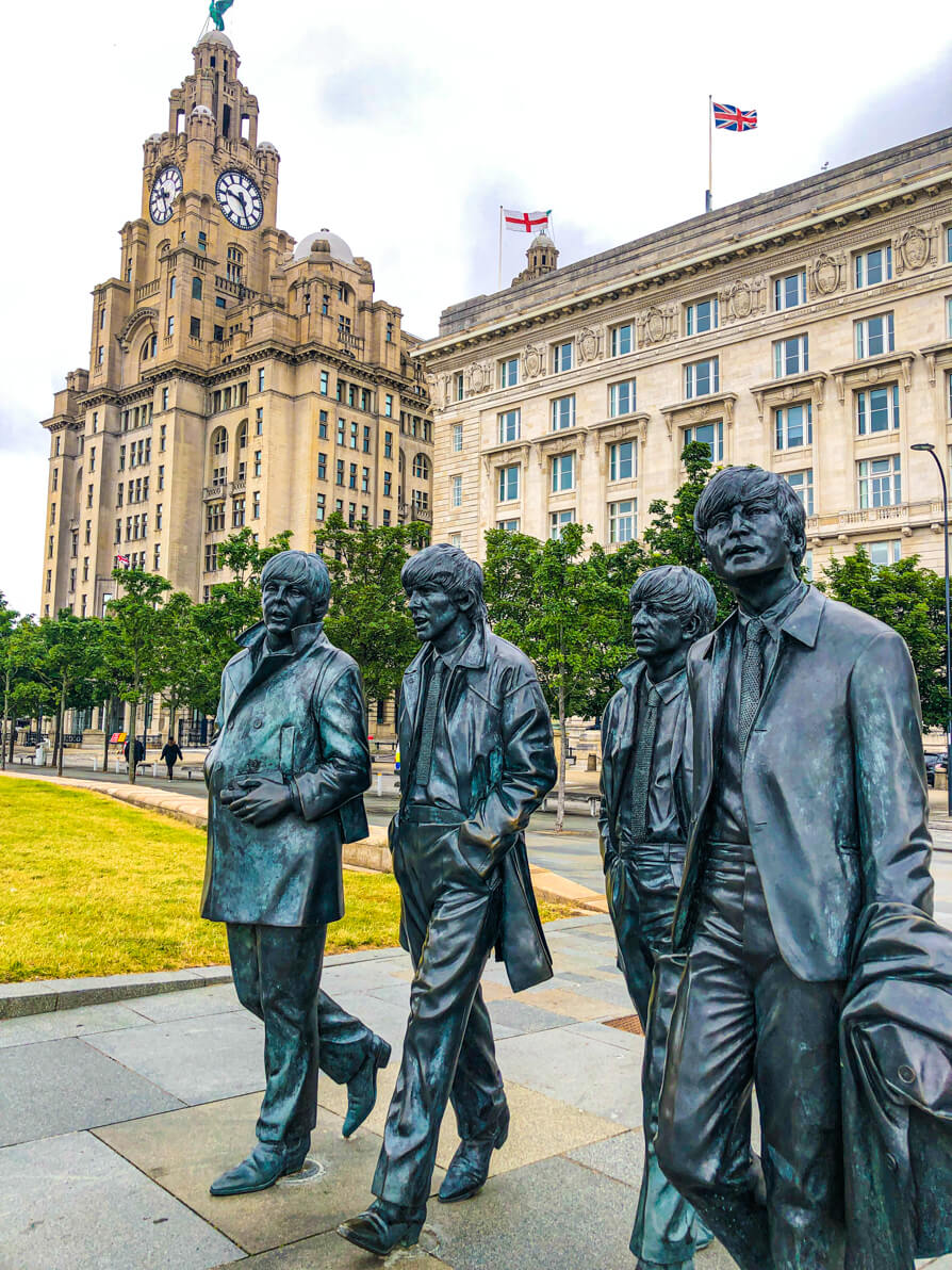 Statue of The Beatles to the right of the image with Royal Live Building in the back left