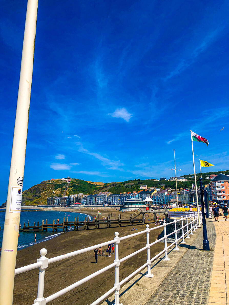 Aberystwyth promenade with flags flying from different countries