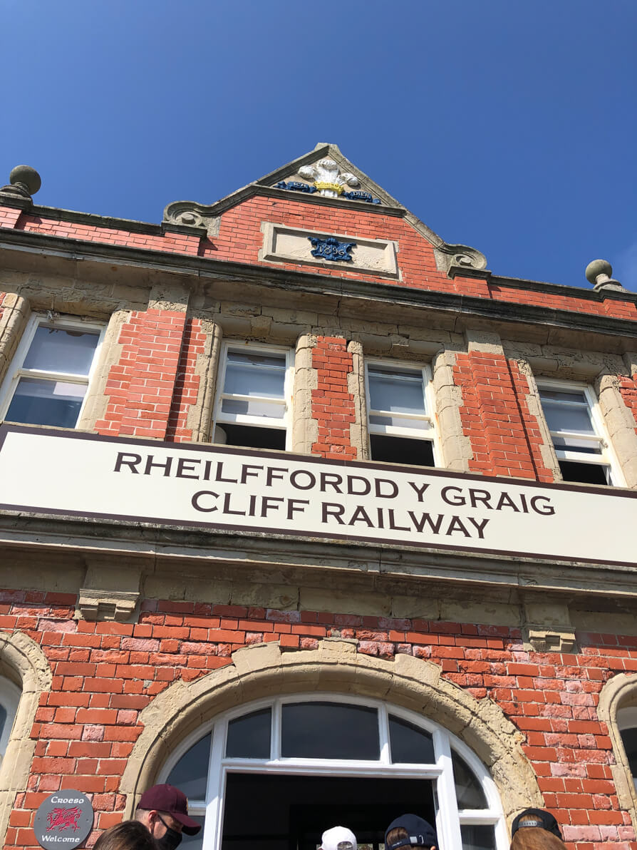 Entrance to the Cliff Railway in Aberystwyth. Image shows red building with Cliff Railway sign in English and Welsh