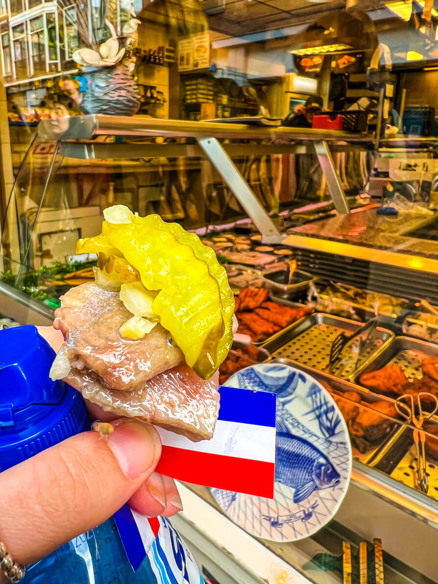 Image of Herring on a stick with Dutch flag, onions and pickles in Jordaan Amsterdam