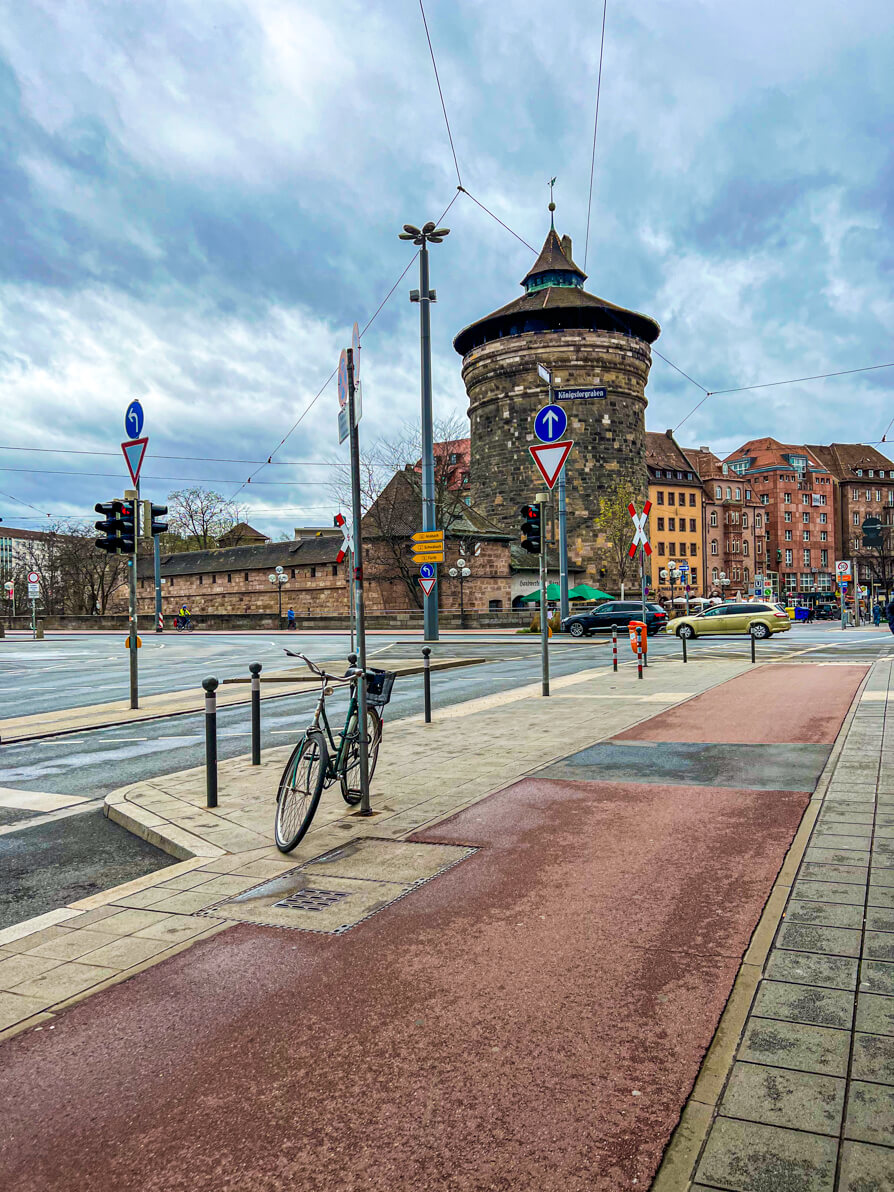 Street view of Nurnberg Castle overlooking the old town of Nuremberg Germany with a bike in forefront on photo leaning on a lamppost 