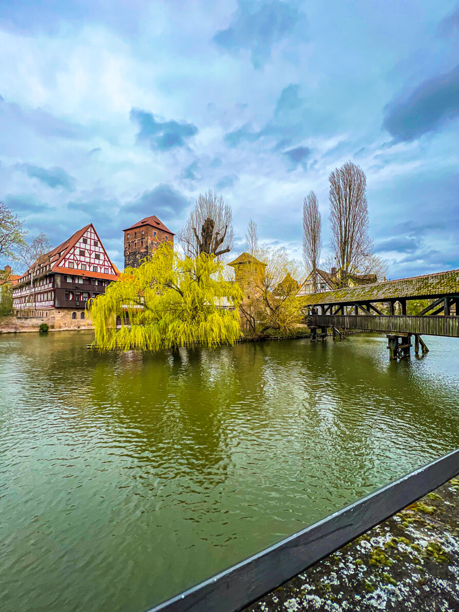 Maxbrucke hangman bridge with river and house and trees in background in Nuremberg Germany 