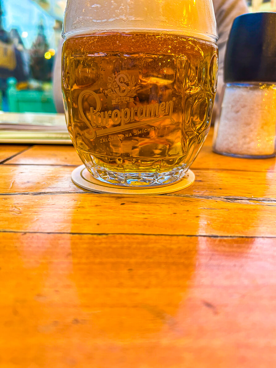 Image of pint of Staropramen beer in in Old Town Square Prague Czech Republic