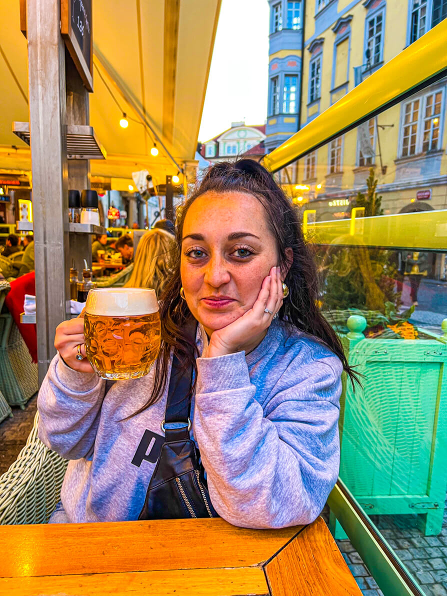 Shireen holding a pint of Staropramen Beer in the Old Town Square Prague Czech Republic