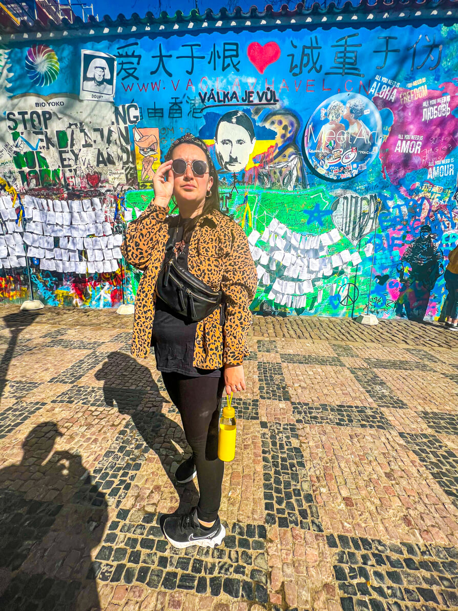 Shireen stood next to the art portraying Putin as Hitler on the Lennon Wall in Prague