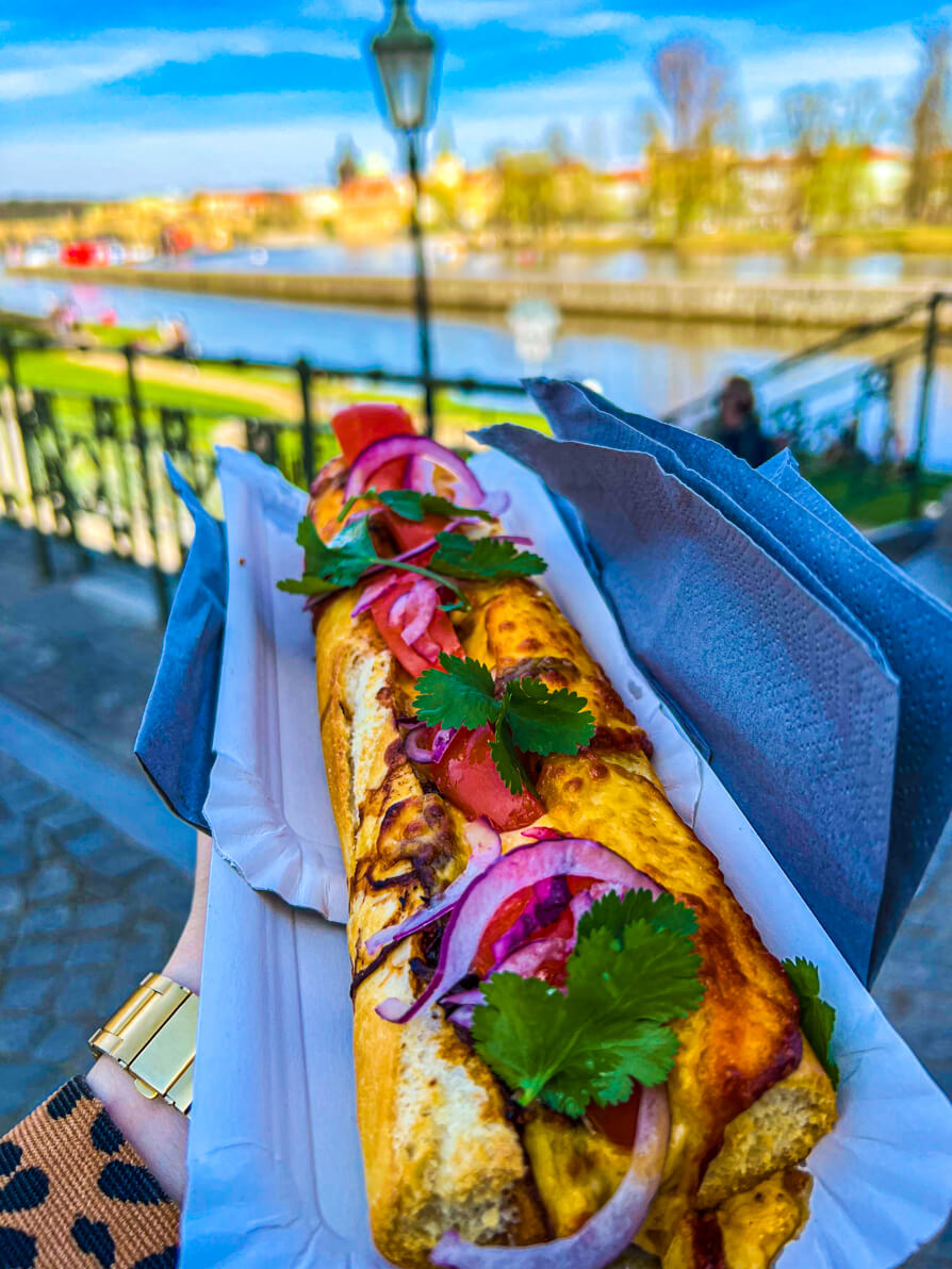 Image of baguette from Kampa Bistro in Prague with River Vltava in background 
