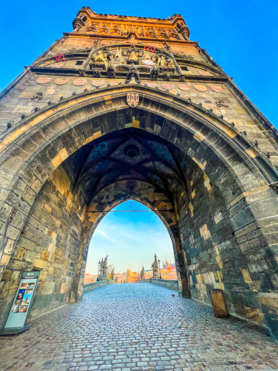 Entrance of Charles Bridge at sunrise in Prague