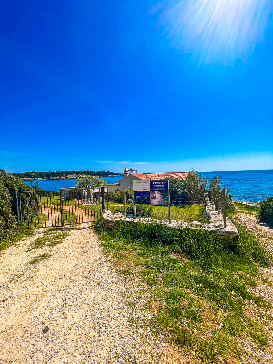 The path and lighthouse and house at the top of Beach Svjetionik in Verudela Pula Croatia