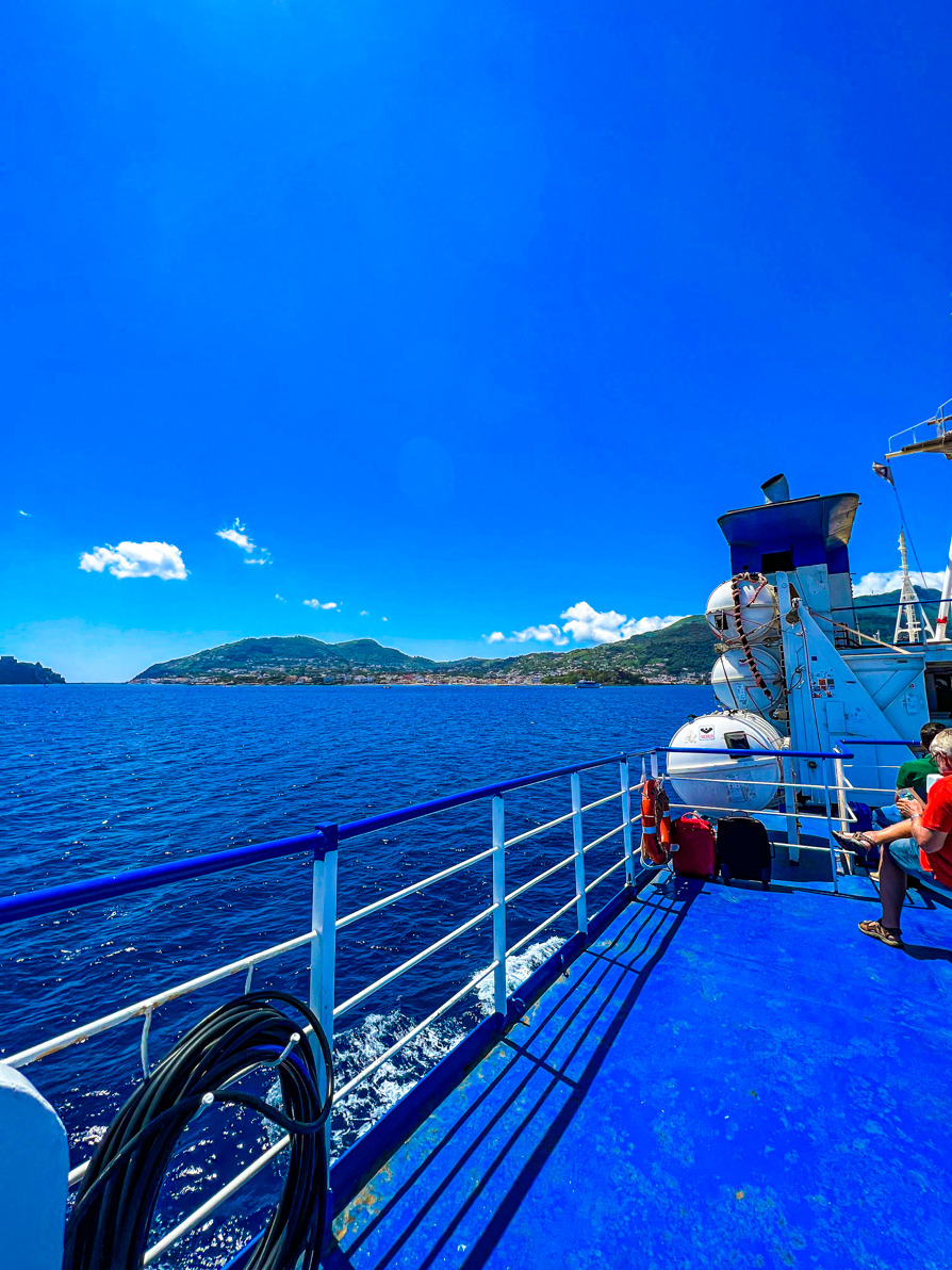 Image of left hand side of the Caremar ferry going from Naples to Ischia with sea and Ischia island in the background