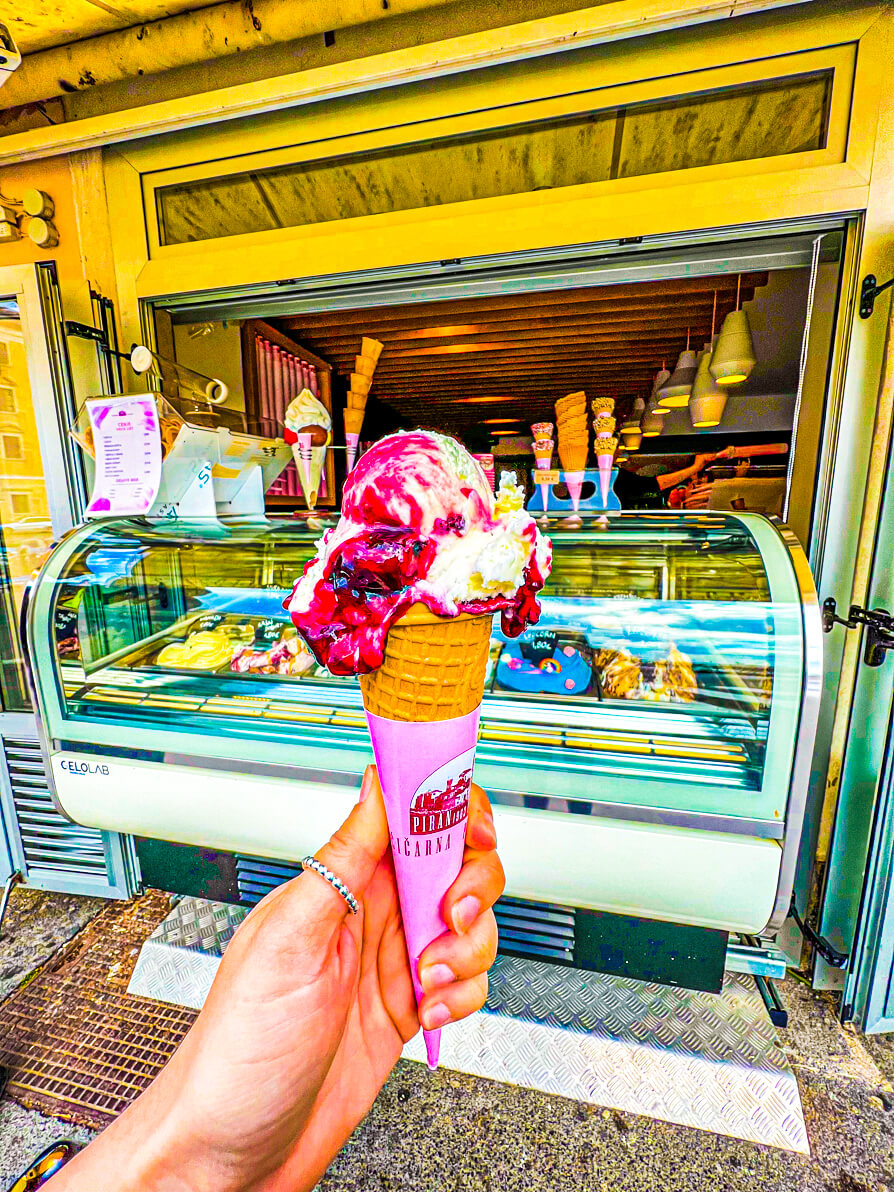 Image of Shireen's left hand holding up the raspberry ice cream in Piran Slovenia