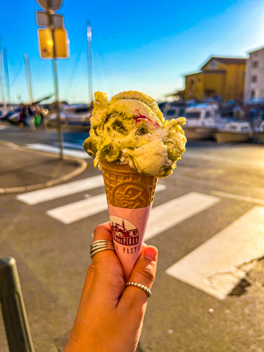 Image of Shireen's left hand holding up the pistaccio ice cream in Piran Slovenia