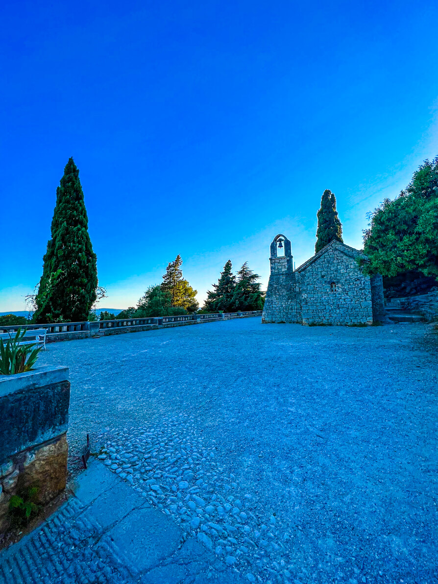 Image of St Nicholas Church in the background with stones in front in Marjan Park