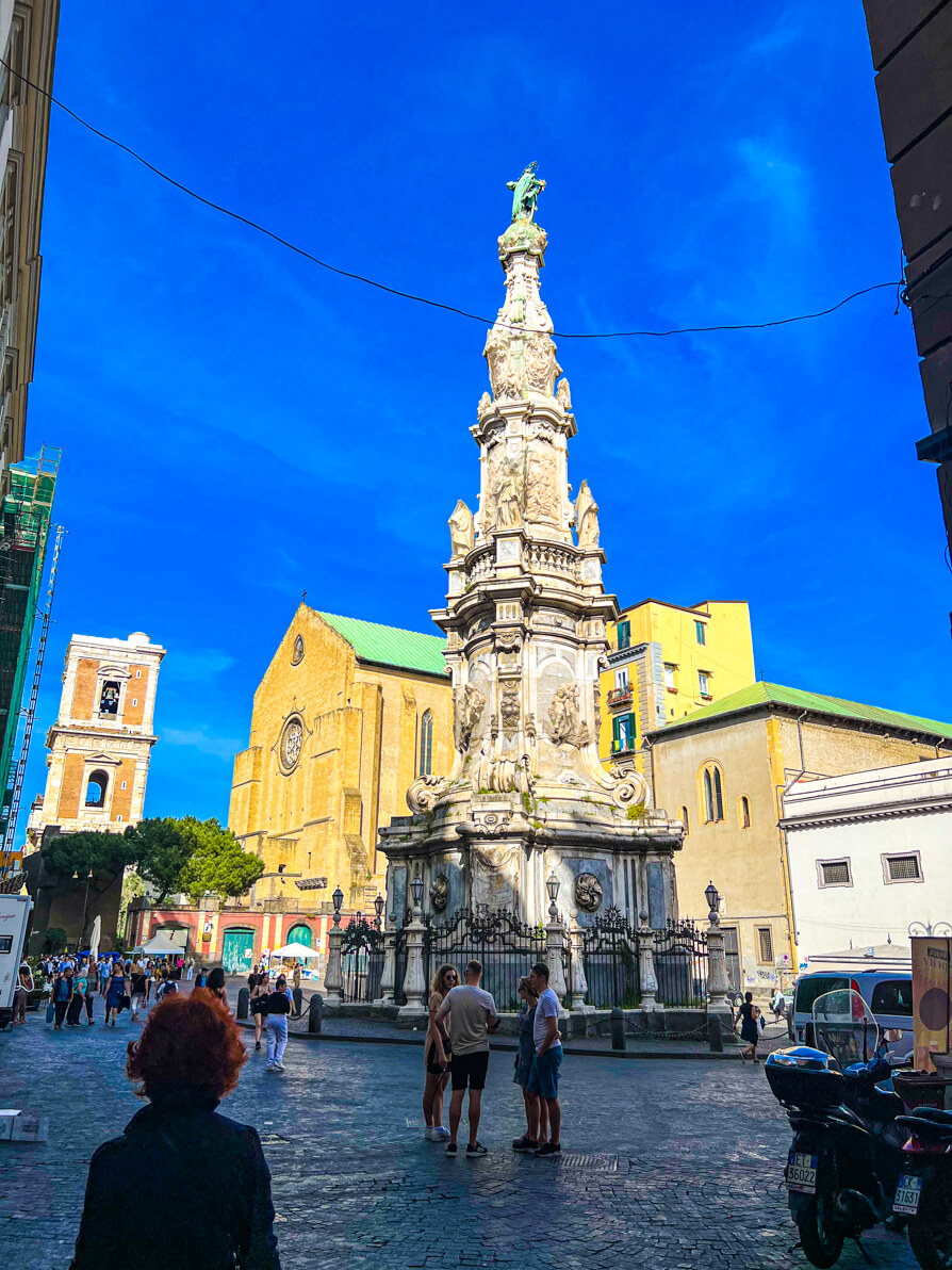 Image of church and monument in popular square in Naples Italy