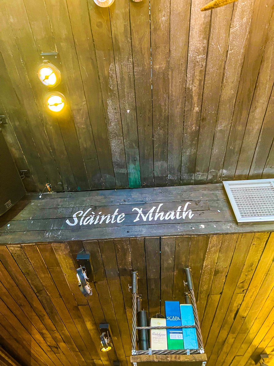 Image shows the word for cheers 'Slainte' on a wall in a pub in Edinburgh Scotland
