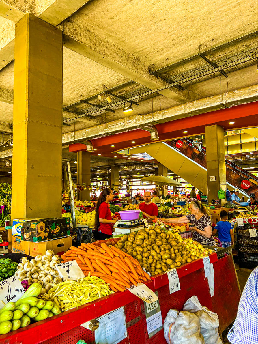 Interior of Obor market with colourful vegetables on tables in front