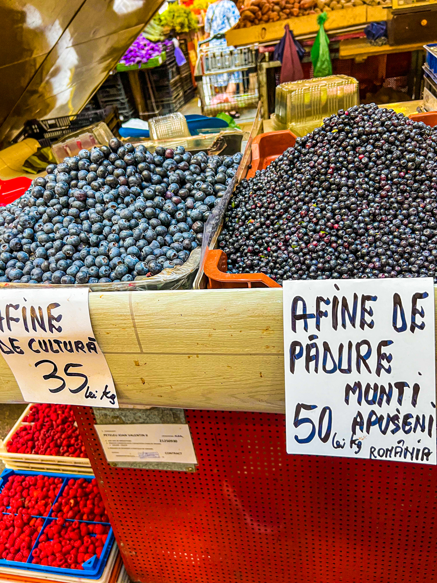 Image of two heaps of blueberries next to one another in Obor market in Bucharest Romania