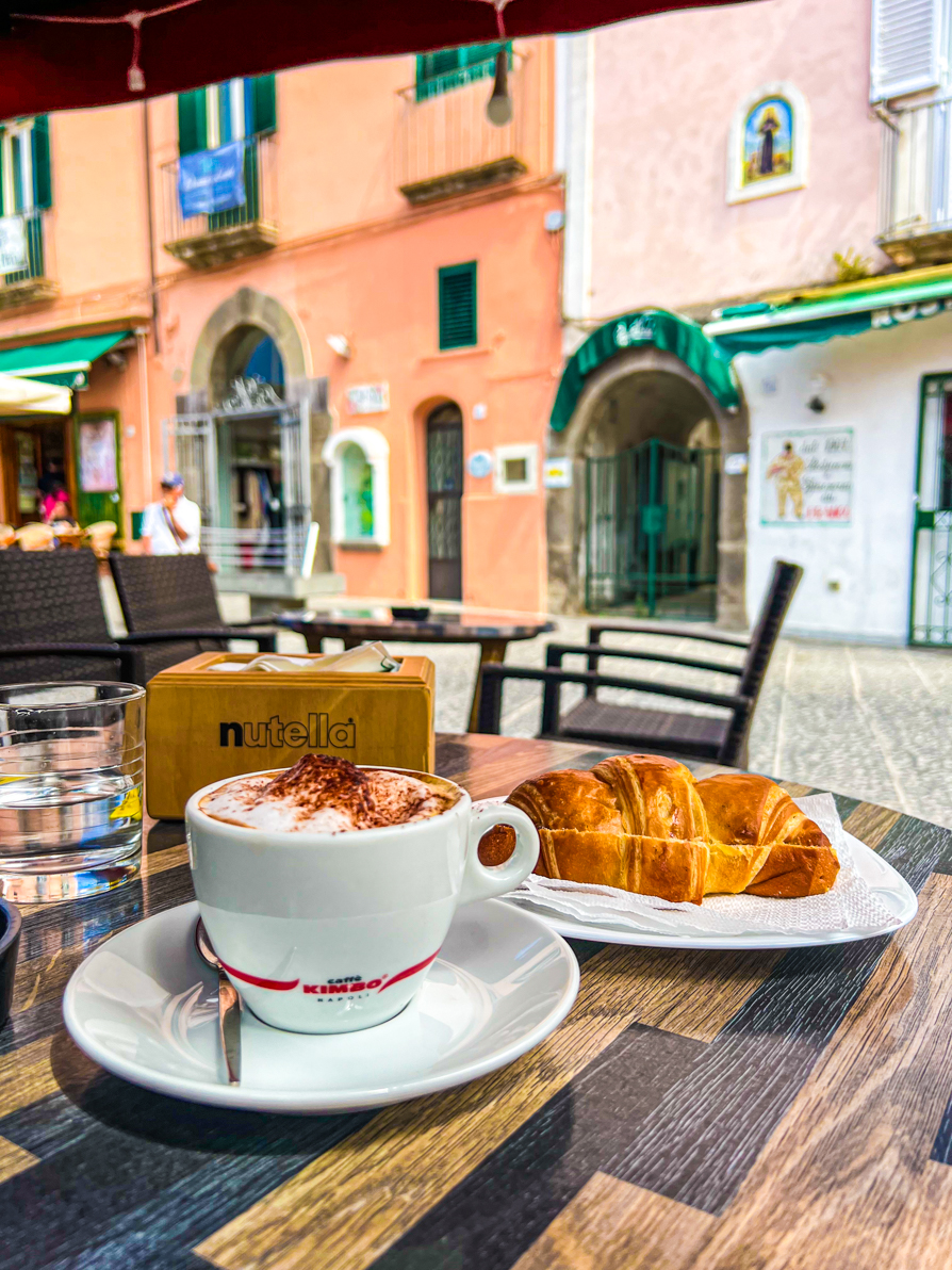 Image of nutella cornetto and cappucino on a table in Italy
