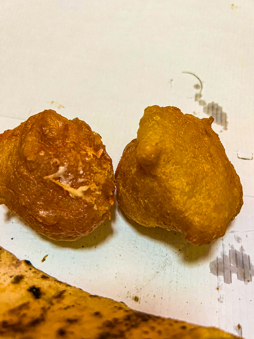Image of two fried pizza dough balls on a white box in Italy