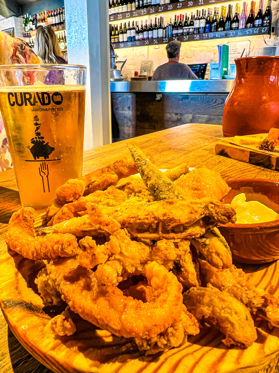 Image of fritura de pescado with Curado beer glass in background