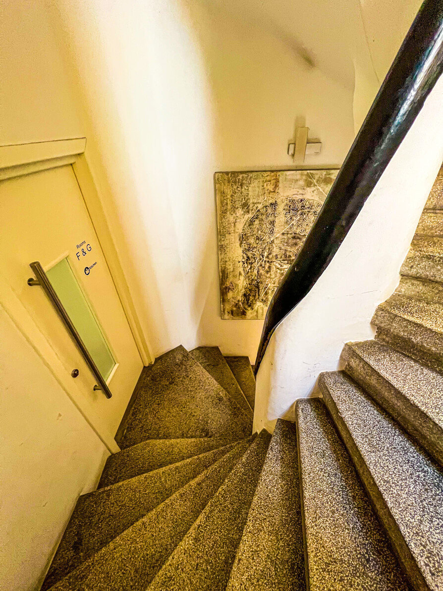 Image of spiral stairs in First Hostel Bucharest leading to rooms D,E,F