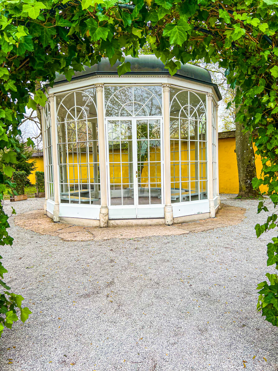 Image of the Sound of Music gazebo at Hellbrunn Palace with arch of flowers overhead in Salzburg Austria