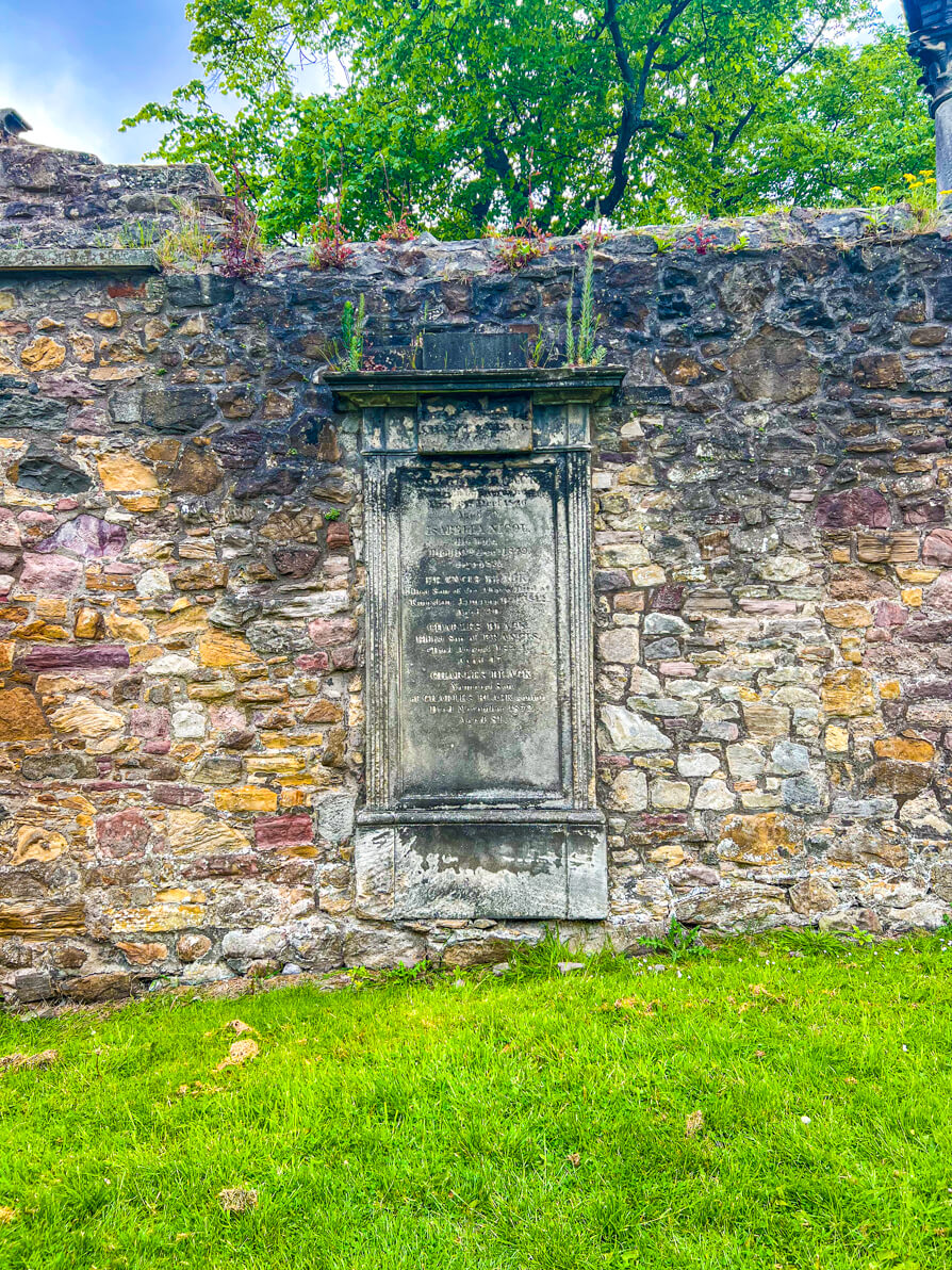 wide image of Black grave in Greyfriars Kirkyard Harry Potter Graveyard in Edinburgh Scotland