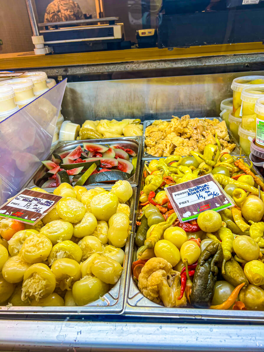 Image of pickled options in market including picked vegetbles and pickled fruit in Romania