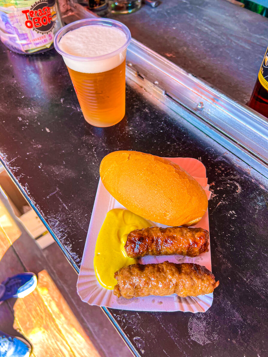 Image of Mici, mustard, bread and beer in Bucharest Romania