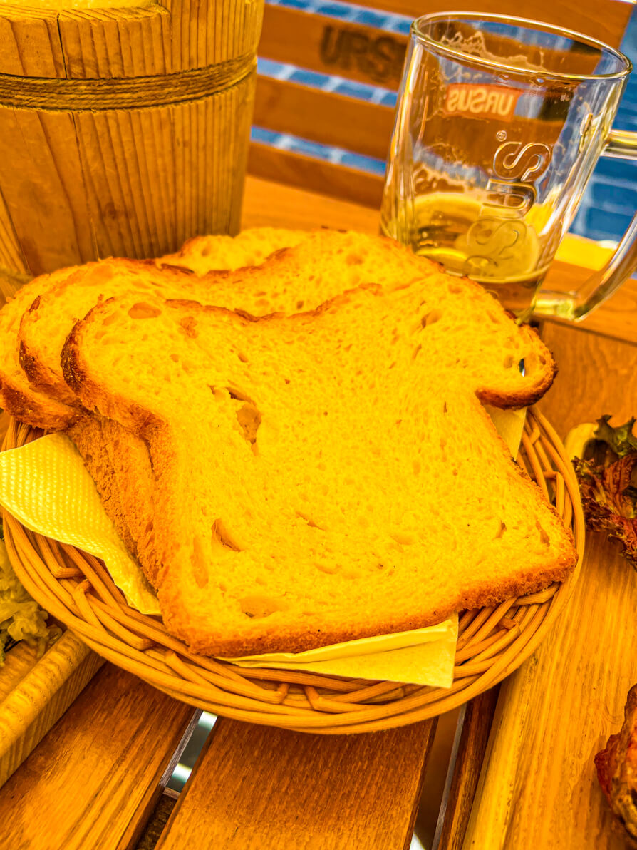 Image of three slices of Transylvanian potato bread in a wicker basket in Brasov Romania