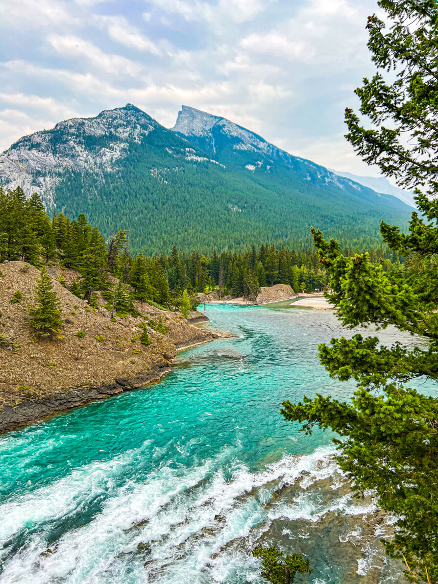 Image of blue Bow River and Mount Rundle in Banff Canada. 
