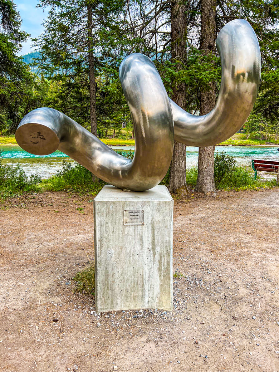 Image of silver stone statue on display on Bow Falls trail in Banff Canada