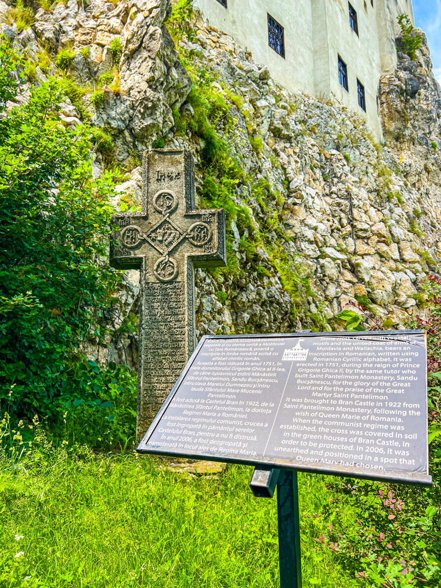 Image of information board and stone in front of Bran Castle in Romania